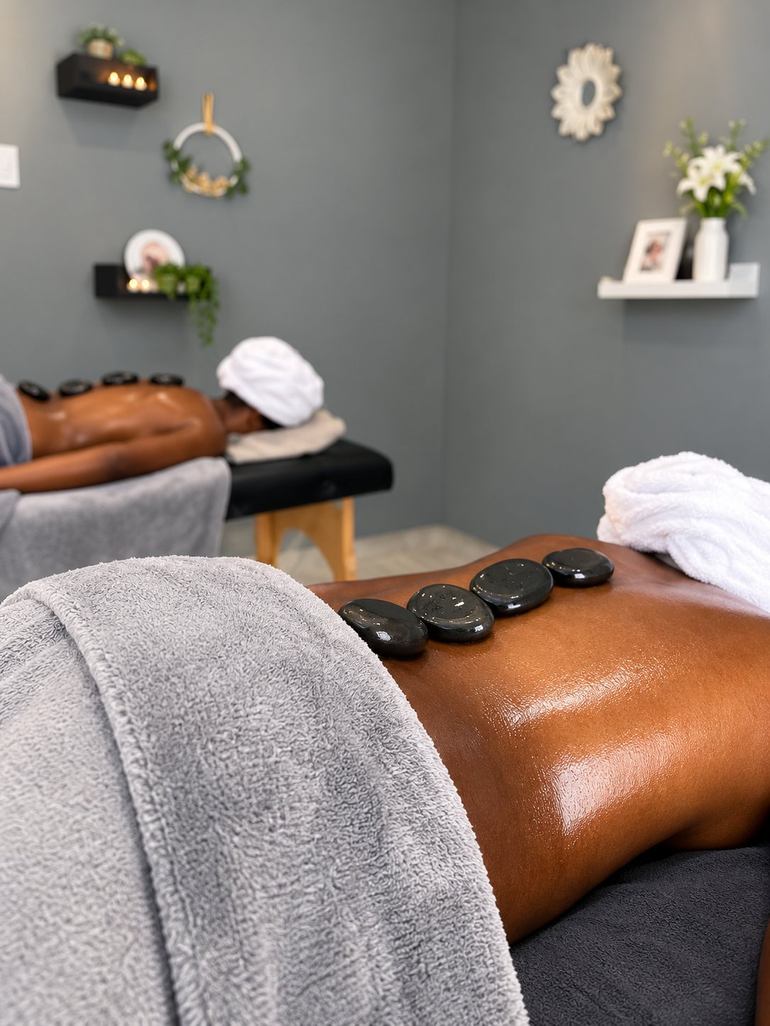 Warm massage stones arranged along a guest?s back during a spa treatment